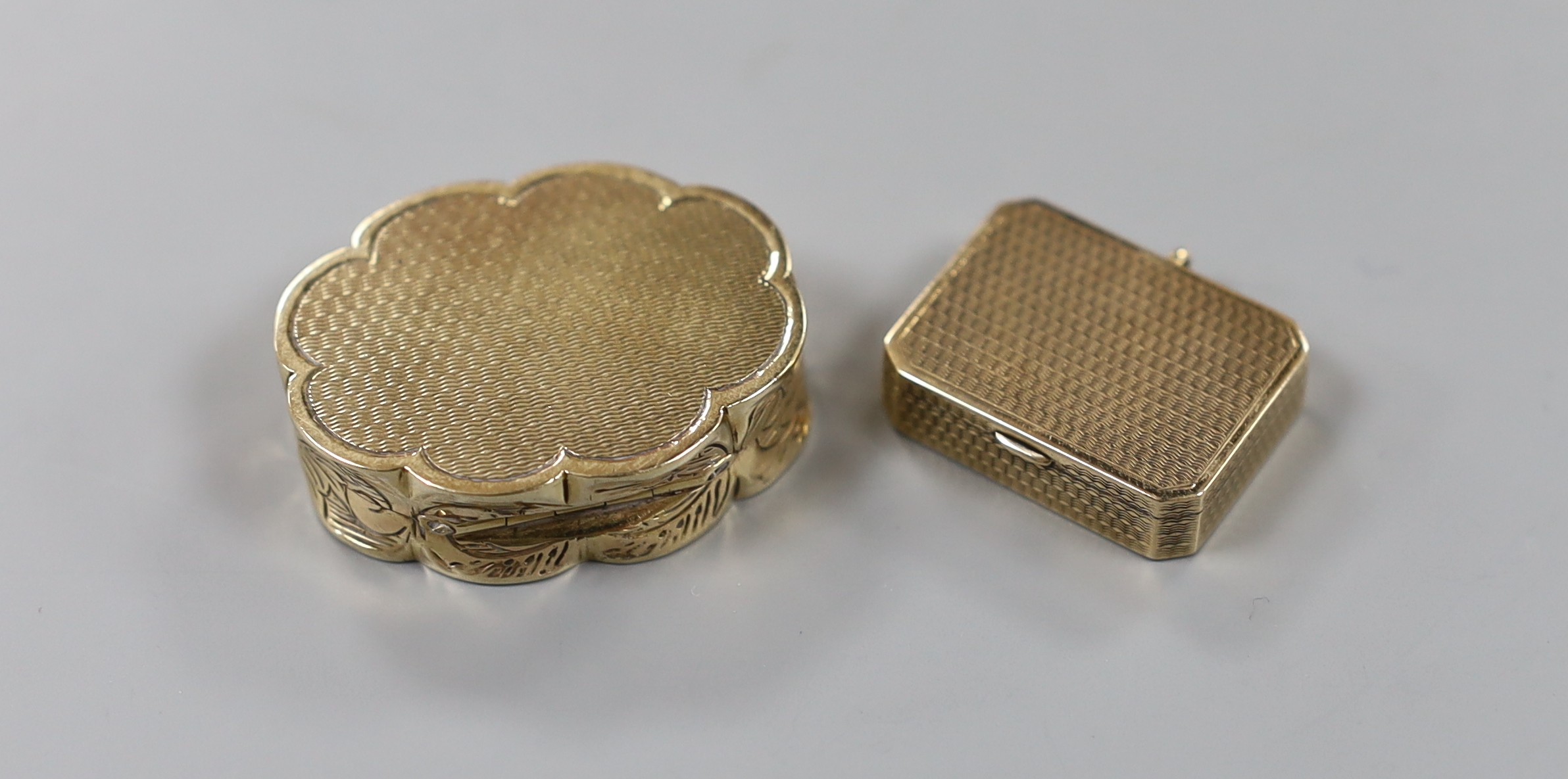 A 1960' 9ct gold shaped oval pill box, 35mm, 22.5 grams and a 9ct gold pill box by Asprey & Co, London, 1925, 25mm, 7.6 grams.